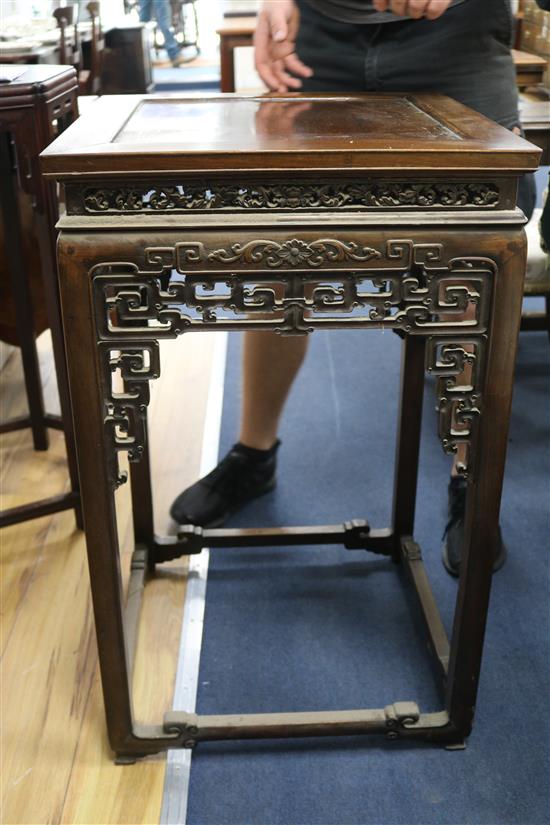 A Chinese huali wood urn stand, having panelled top and pierced frieze W.52cm